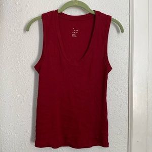 Red Tank top muscle tee cut with thick hemline along whole garment